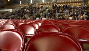 Red Chairs with Audience in Back